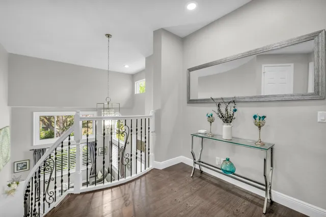a view of a white house with a big yard and large trees