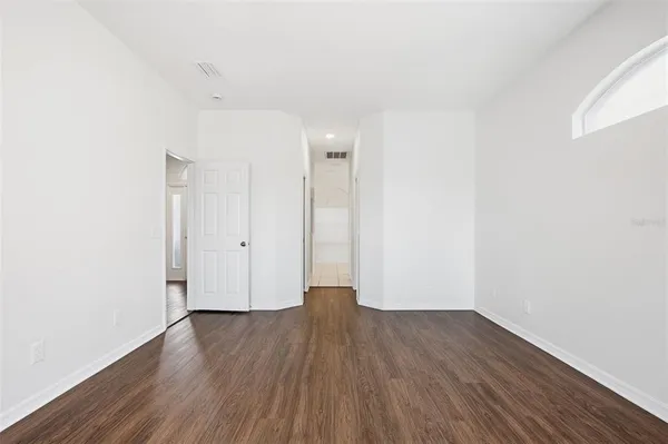 a view of a room with wooden floor