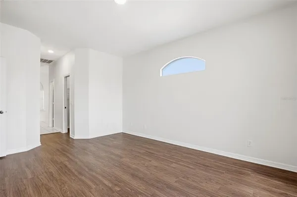 a view of a room with wooden floor and white walls