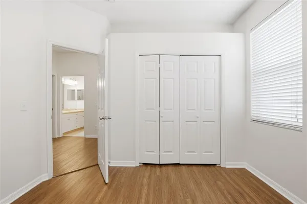 an empty room with wooden floor and a window