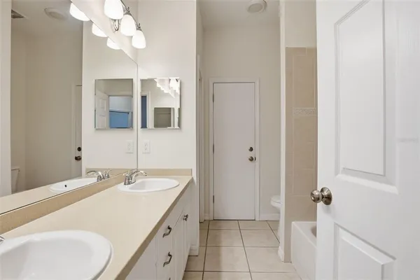 a bathroom with a sink vanity and a mirror