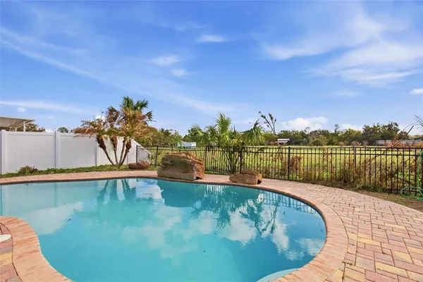 a view of a swimming pool with an outdoor seating