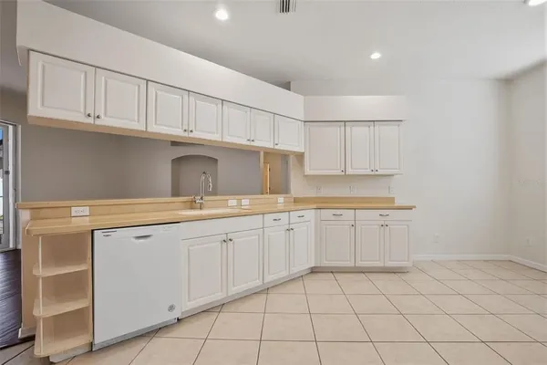 a kitchen with sink cabinets and utility