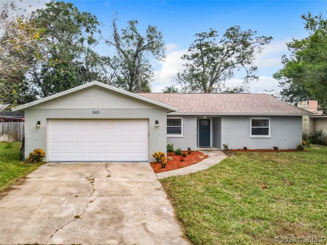 a front view of a house with garage