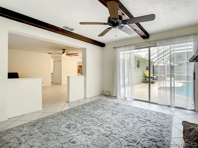 a living room with furniture and a ceiling fan
