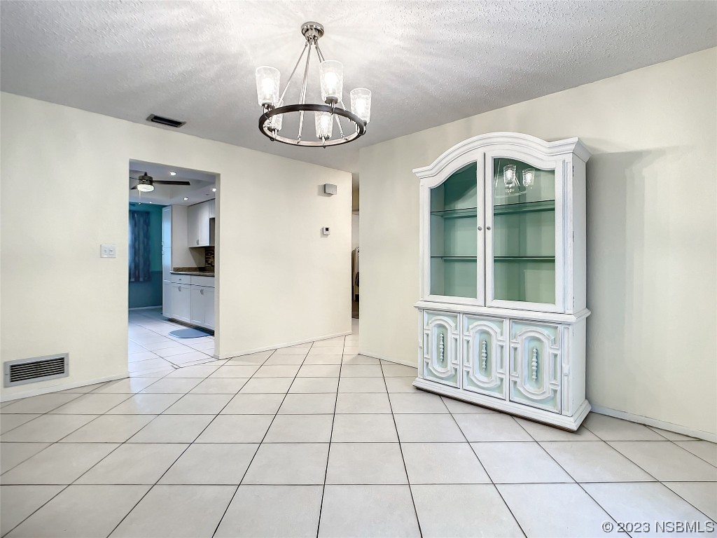 865 North Ridgewood Avenue Ormond Beach, FL 32174 - Photo 15 of 32 a view of an empty room with a chandelier