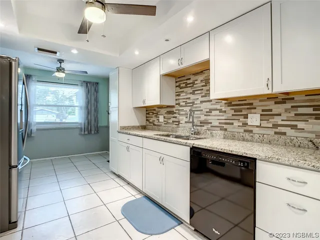 a kitchen with stainless steel appliances granite countertop a sink and cabinets