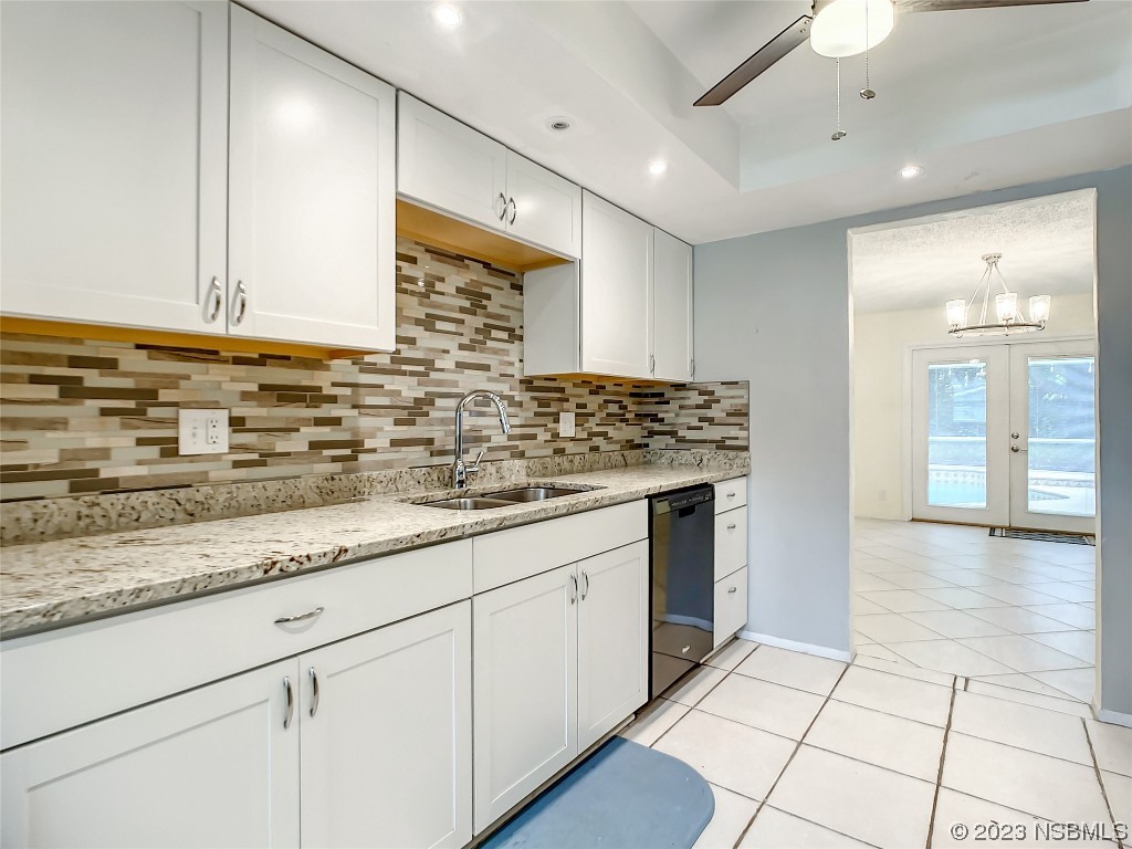 865 North Ridgewood Avenue Ormond Beach, FL 32174 - Photo 18 of 32 a kitchen with stainless steel appliances granite countertop a sink and cabinets