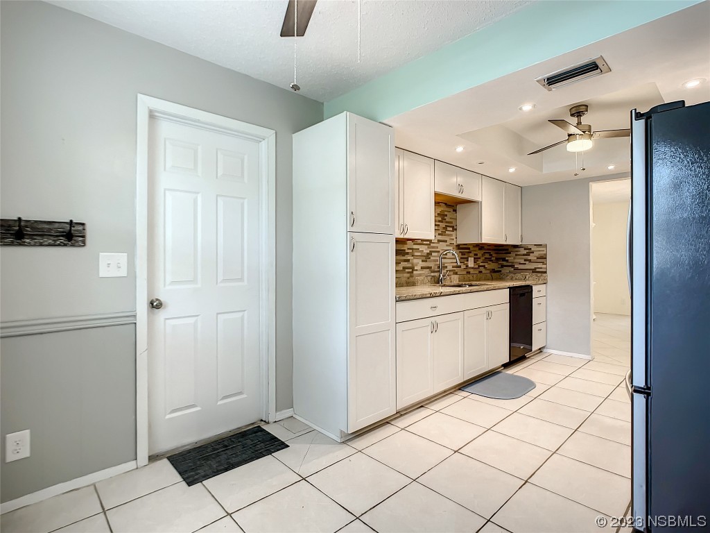 865 North Ridgewood Avenue Ormond Beach, FL 32174 - Photo 20 of 32 a kitchen with granite countertop a refrigerator and a stove top oven