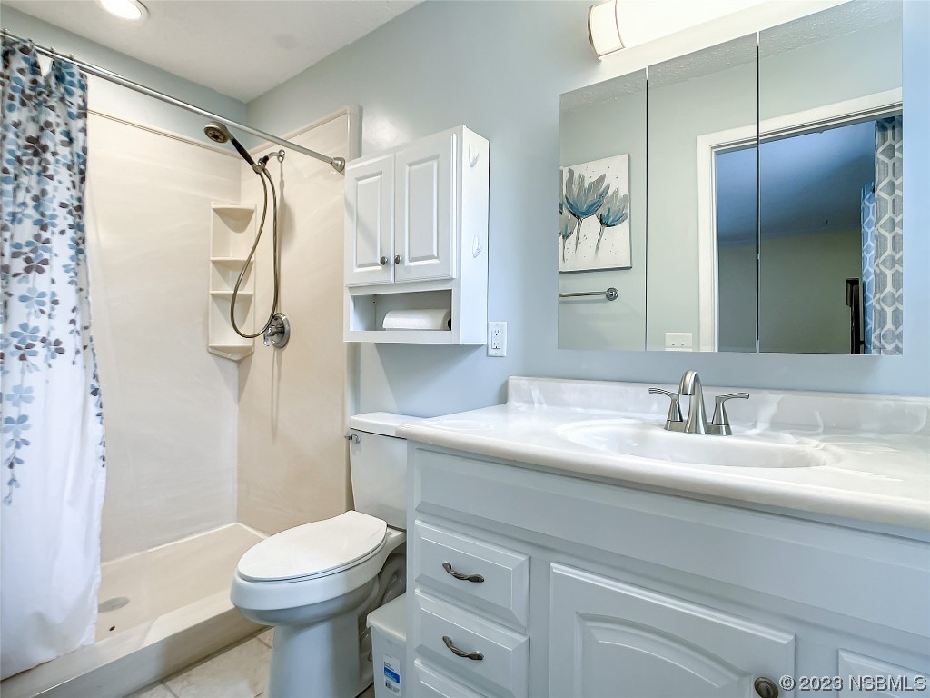 865 North Ridgewood Avenue Ormond Beach, FL 32174 - Photo 22 of 32 a bathroom with a sink a toilet and shower