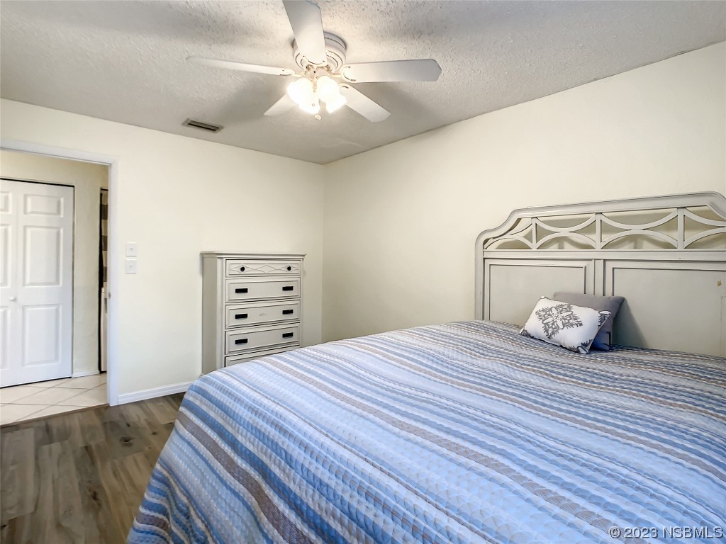 865 North Ridgewood Avenue Ormond Beach, FL 32174 - Photo 27 of 32 a bedroom with a bed and a chandelier