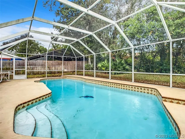 a view of a backyard with swimming pool