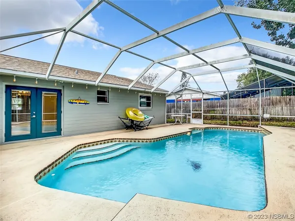 a house view with a swimming pool outdoor seating
