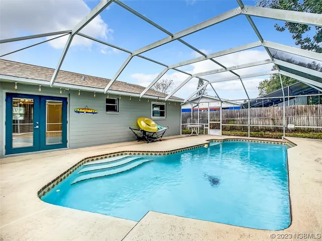 a house view with a swimming pool outdoor seating