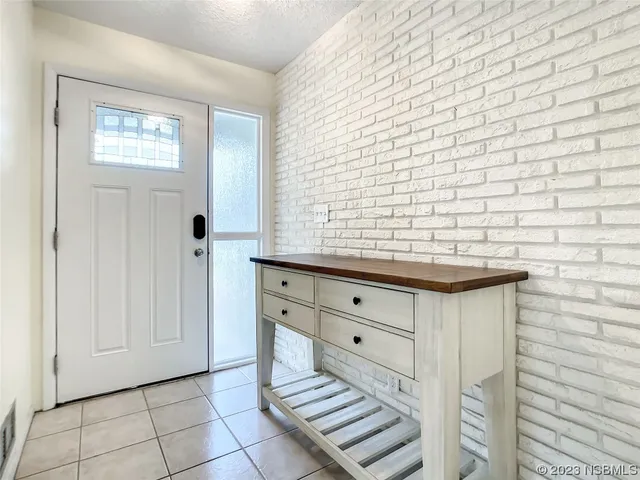 a view of a livingroom with wooden floor and a refrigerator