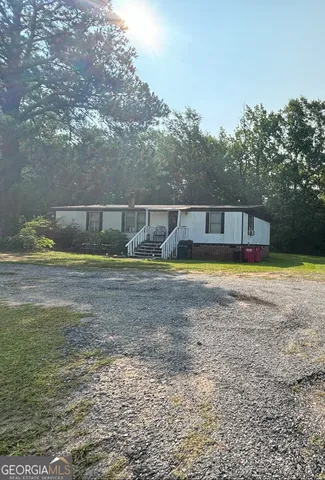 a view of a house with swimming pool and garden