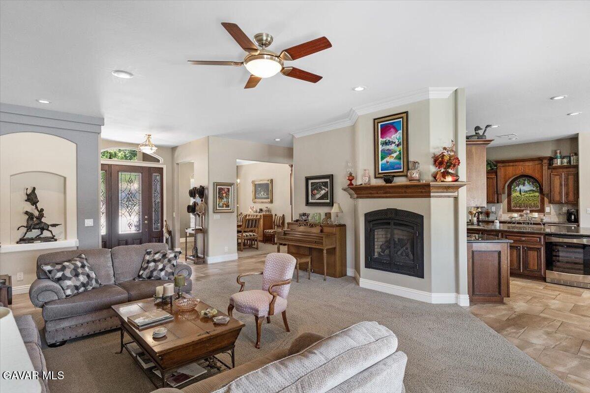 23840 Martingale Way Tehachapi, CA 93561 - Photo 12 of 63 a living room with furniture a fireplace and a flat screen tv