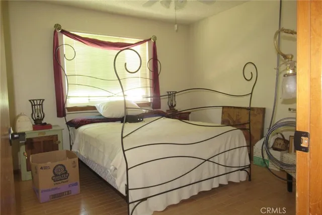 a bedroom with bed and a window