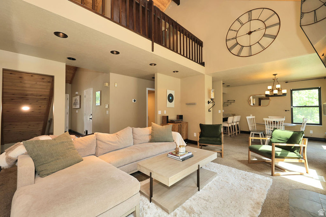 3104 East High Danish Road Sandy, UT 84093 - Photo 13 of 36 Spacious living area featuring a high vaulted ceiling, recessed lighting, and a second-story interior balcony with wood railing