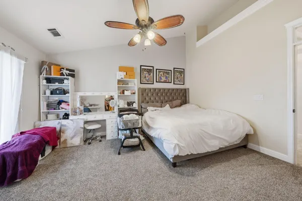 a bedroom with a bed and a book shelf