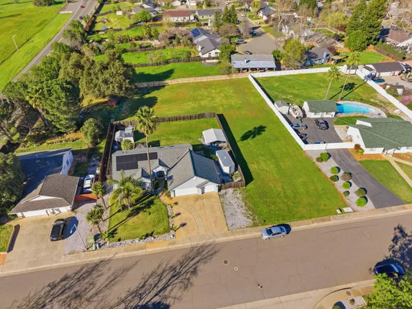 an aerial view of a house with a swimming pool