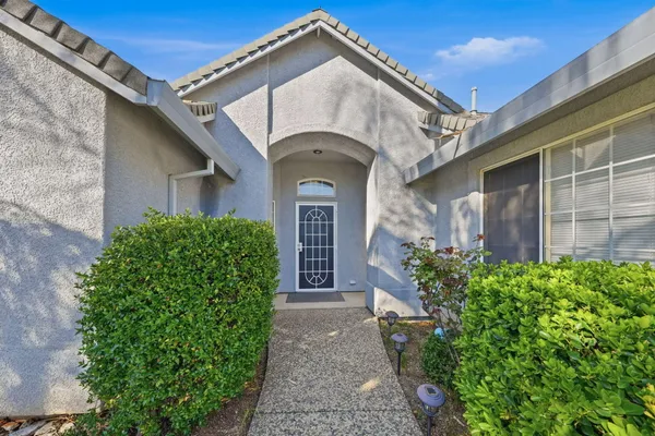 a front view of a house with garden