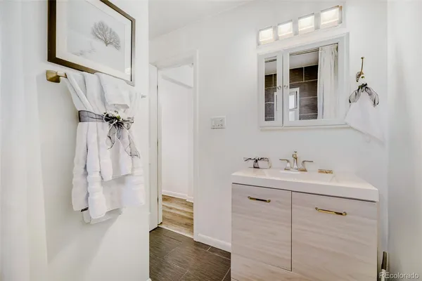 a bathroom with a sink a mirror and shower