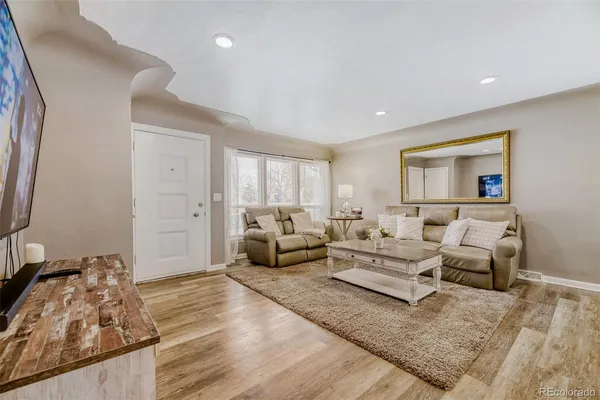 a living room with furniture window and a flat screen tv