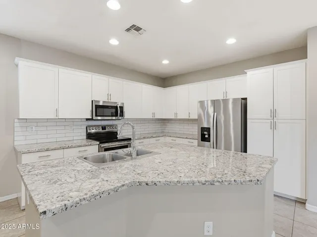 a kitchen with a refrigerator a sink and a stove