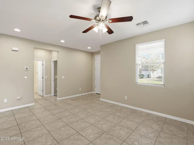 a kitchen with stainless steel appliances granite countertop a stove a sink and a refrigerator with white cabinets