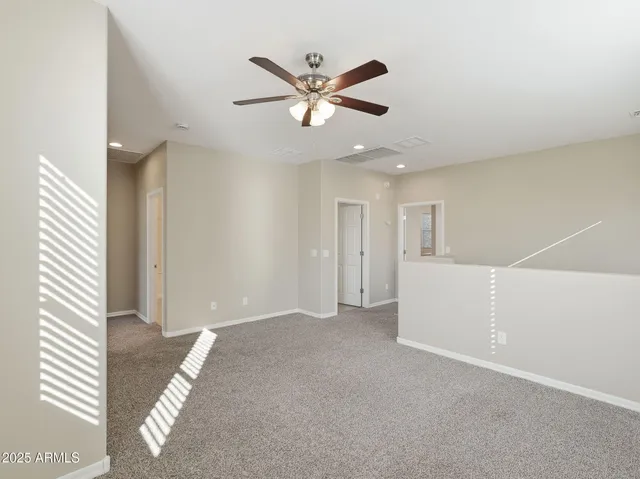 a view of a livingroom with a ceiling fan and window