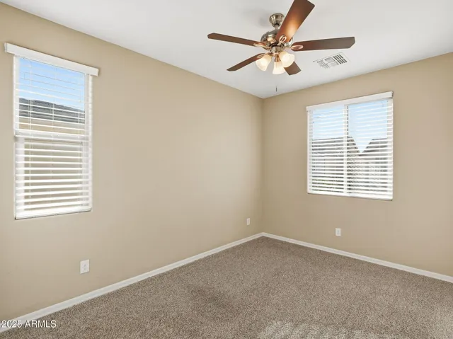 a view of a livingroom with a ceiling fan and window