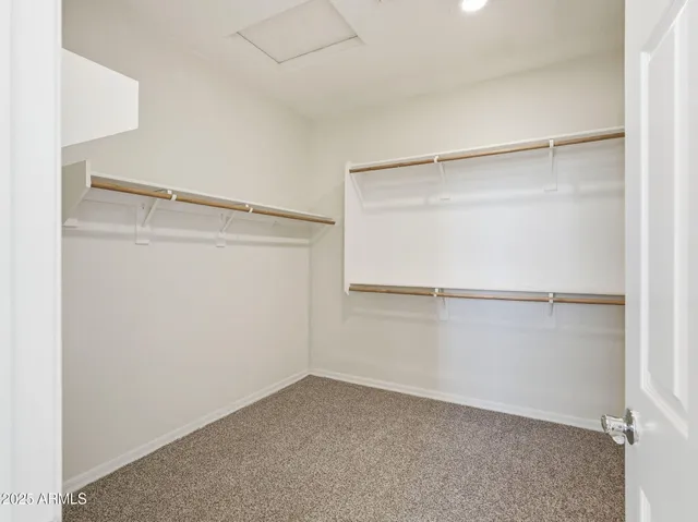 an empty room with chandelier fan