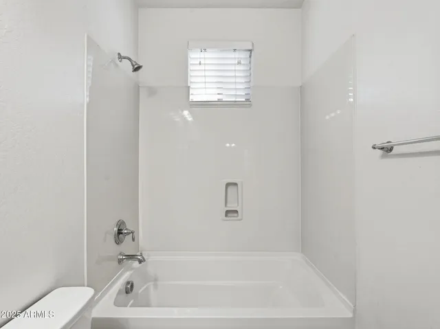 a bathroom with a granite countertop sink toilet and bathtub