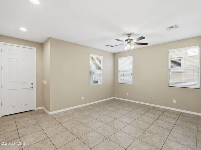 an empty room with fan and a ceiling fan