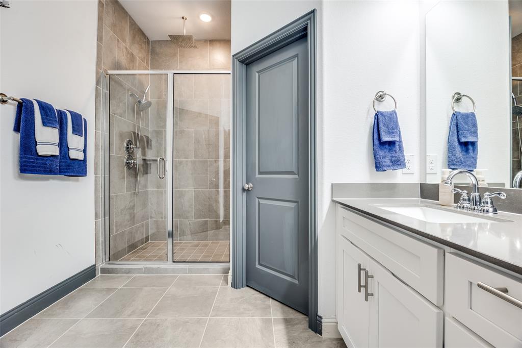 8132 Foraker Street Frisco, TX 75034 - Photo 12 of 25 Bathroom featuring vanity, a stall shower, and light tile patterned flooring