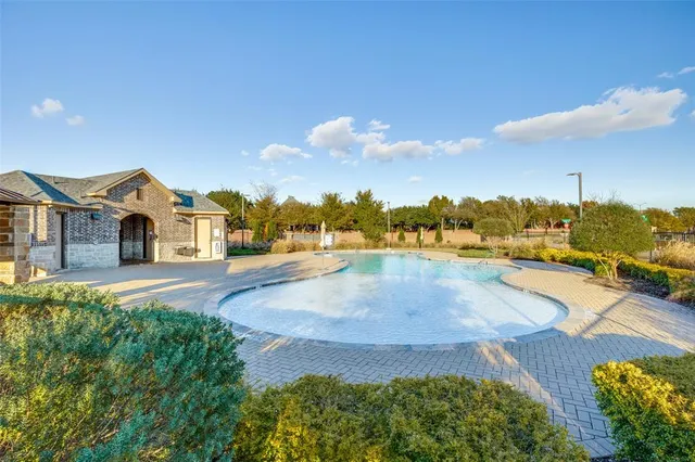 a view of balcony with two chairs and a large window