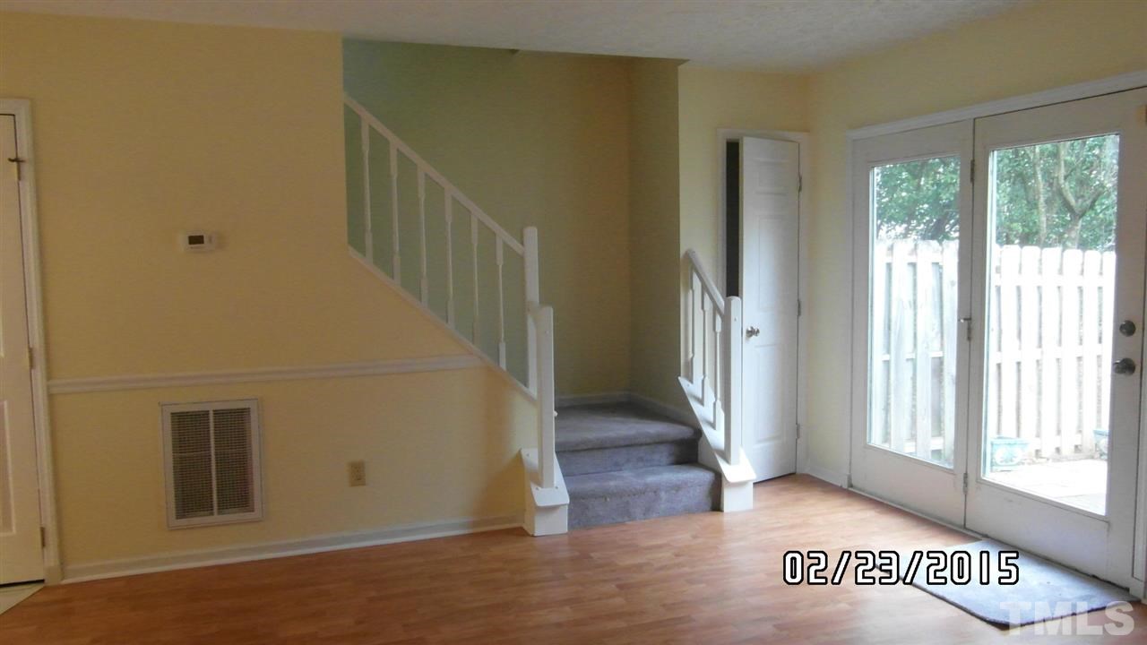 8184 McGuire Drive Raleigh, NC 27616 - Photo 11 of 23 a view of a hallway with wooden floor and windows