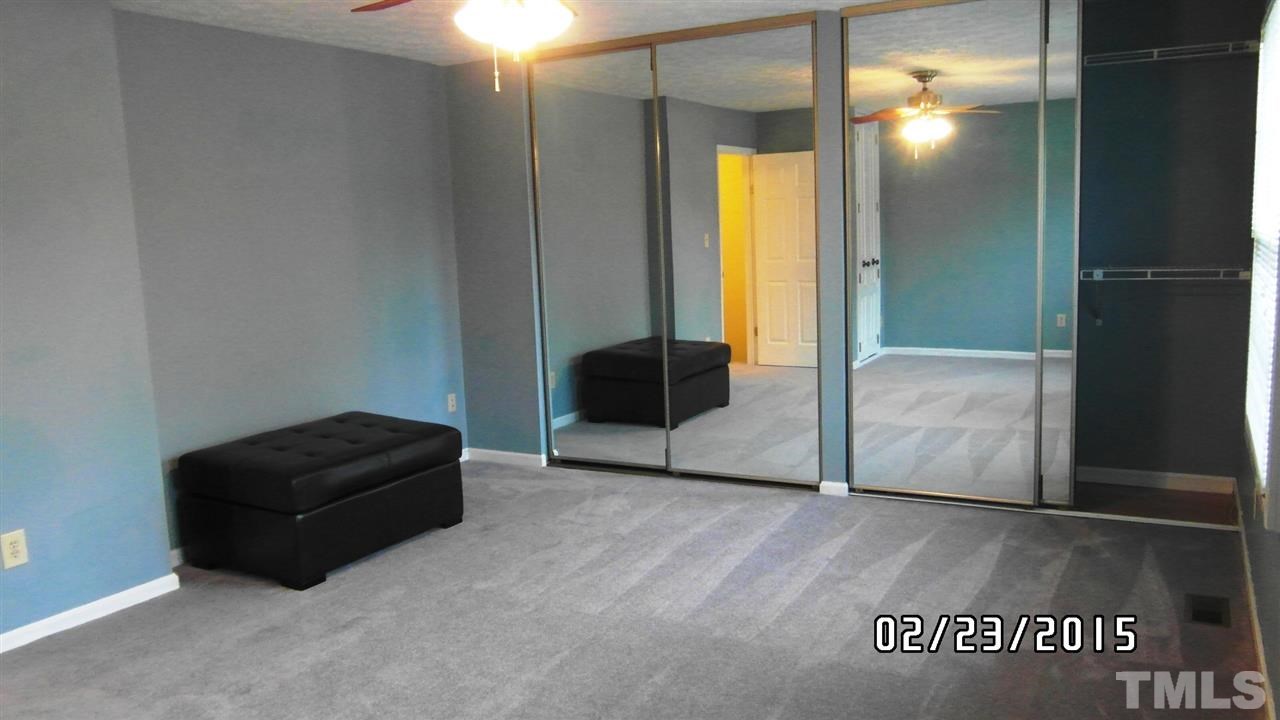 8184 McGuire Drive Raleigh, NC 27616 - Photo 13 of 23 a living room with a couch and a dresser