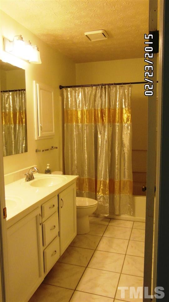 8184 McGuire Drive Raleigh, NC 27616 - Photo 18 of 23 a bathroom with a sink a toilet and shower