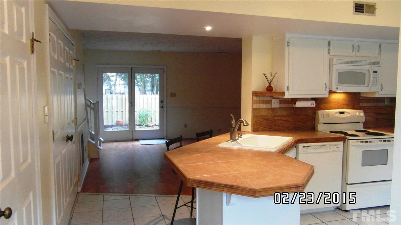 8184 McGuire Drive Raleigh, NC 27616 - Photo 3 of 23 a kitchen with a table chairs and a refrigerator