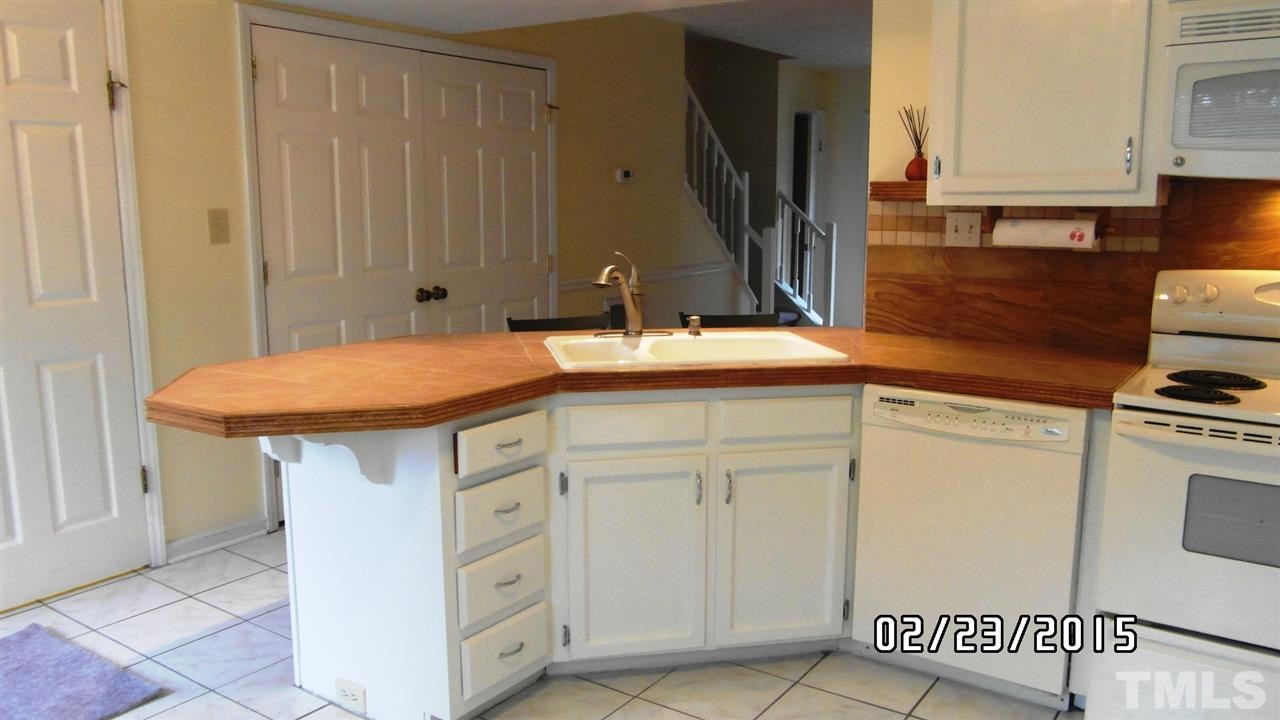 8184 McGuire Drive Raleigh, NC 27616 - Photo 6 of 23 a kitchen with a sink and a refrigerator