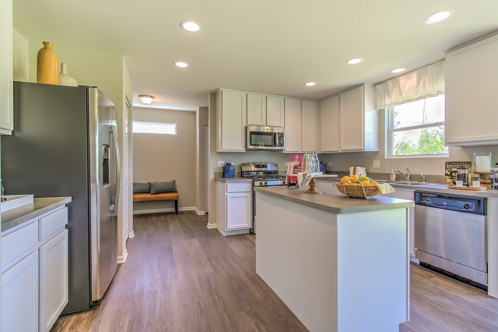 1030 Sharp Drive Plano, IL 60545 - Photo 17 of 36 a kitchen with refrigerator a sink and wooden cabinets