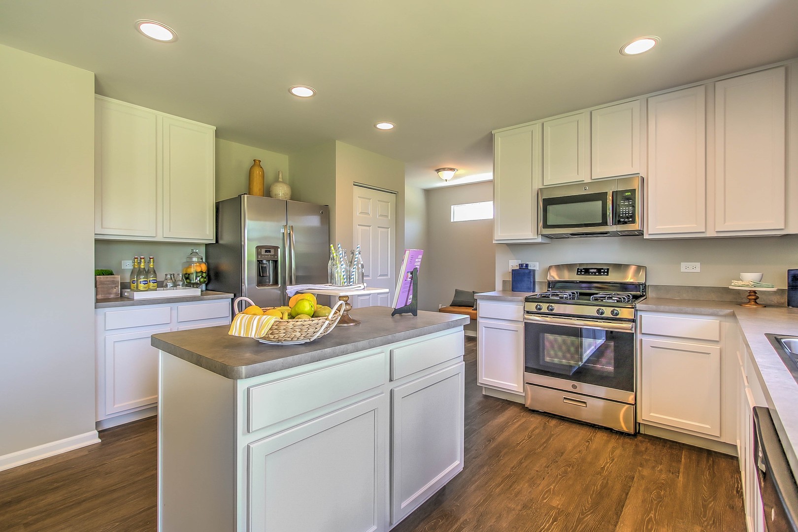 1030 Sharp Drive Plano, IL 60545 - Photo 18 of 36 a kitchen with stainless steel appliances kitchen island granite countertop a stove a sink and a microwave