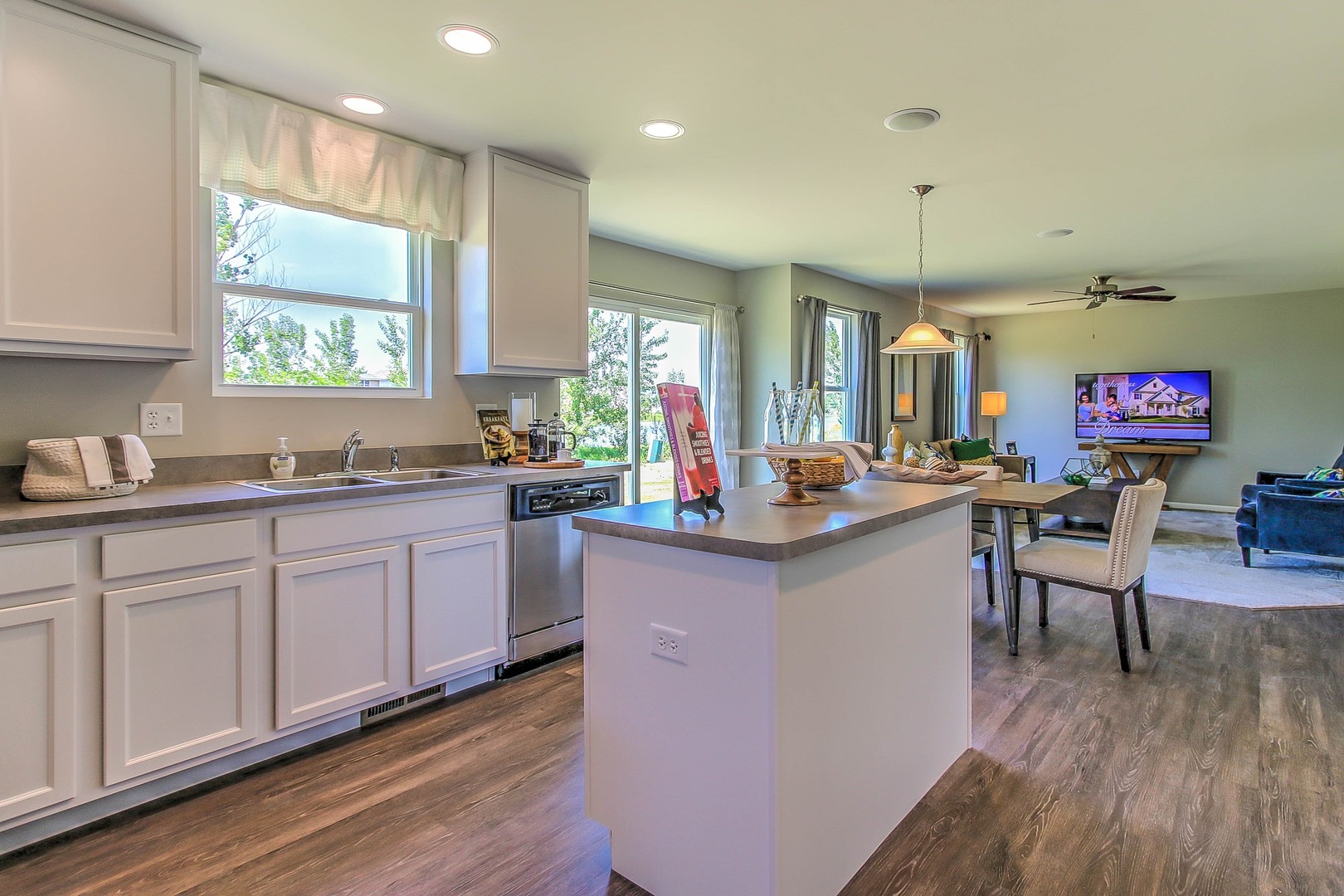 1030 Sharp Drive Plano, IL 60545 - Photo 21 of 36 a kitchen with granite countertop a sink cabinets stainless steel appliances and windows