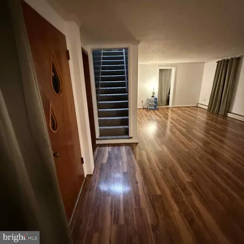 a view of a room with wooden floor