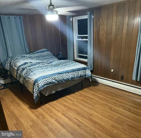 a bedroom with a bed and glass door