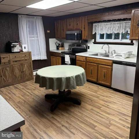 a kitchen with a sink appliances and cabinets