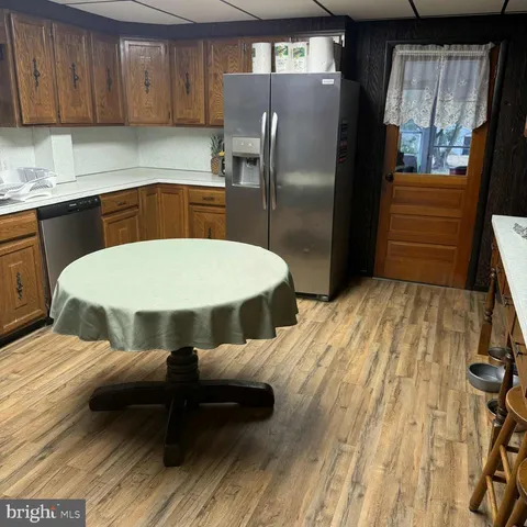 a kitchen with a sink refrigerator and microwave