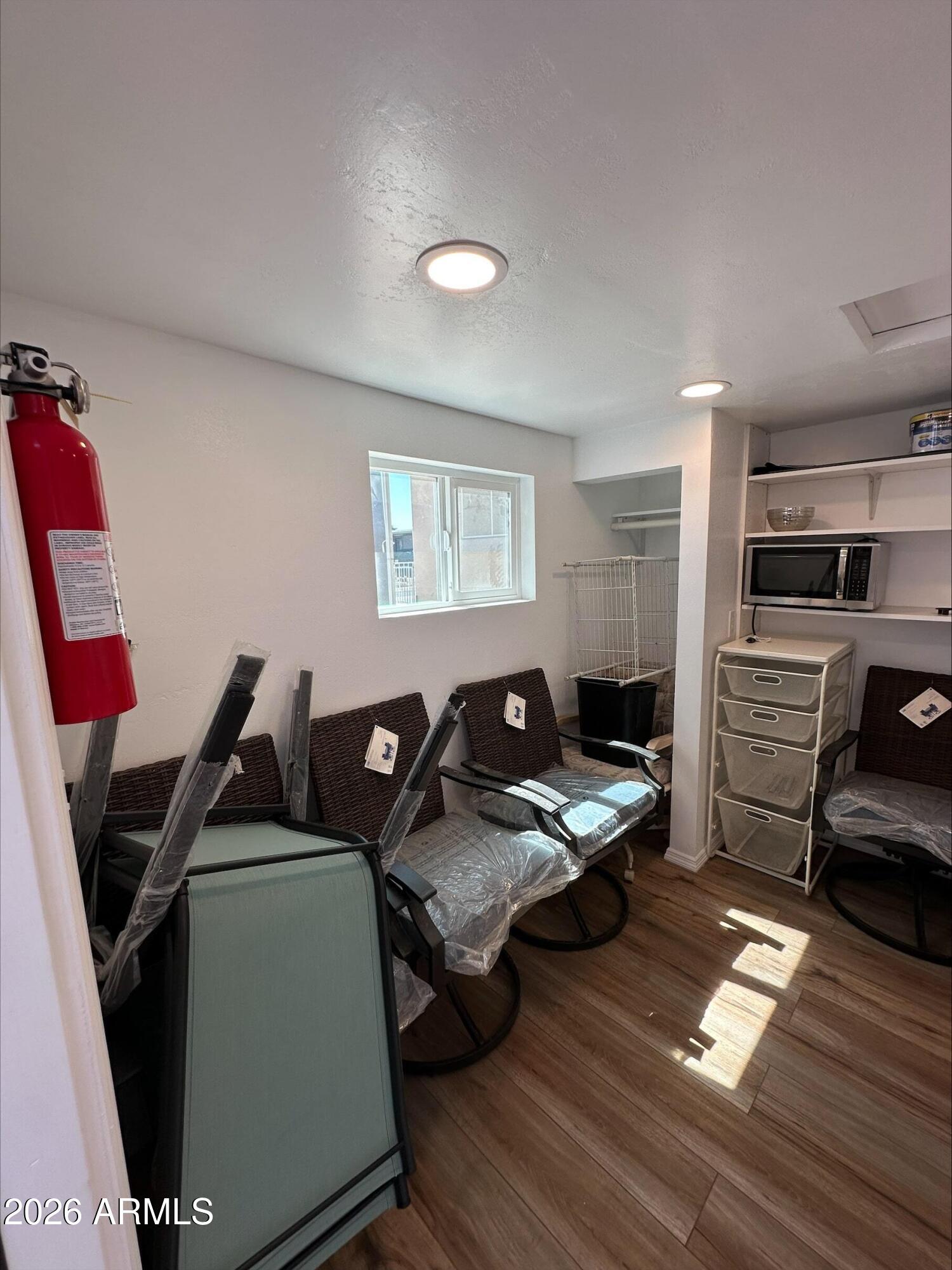 17200 West Bell Road, Unit 1104 Surprise, AZ 85374 - Photo 5 of 6 a bedroom with furniture and a wooden floor